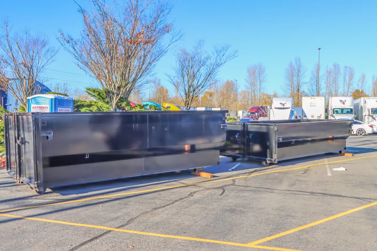 Professional dumpster rental service with roll-off container on residential driveway in Mount Horeb